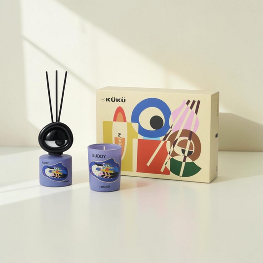 Good Bounty WEKÜKÜ Buddy home fragrance set featuring a purple illustrated candle and diffuser with a gift box.