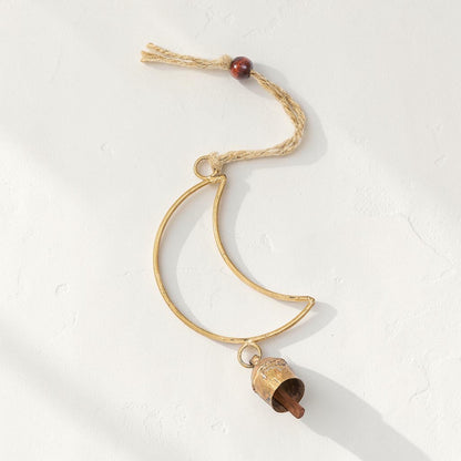 Good Bounty handcrafted crescent moon wind chime with a brass bell, wooden bead, and jute hanging loop.