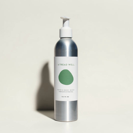 Good Bounty & Tread Well natural hand and body wash in a silver aluminum bottle with a white pump dispenser.